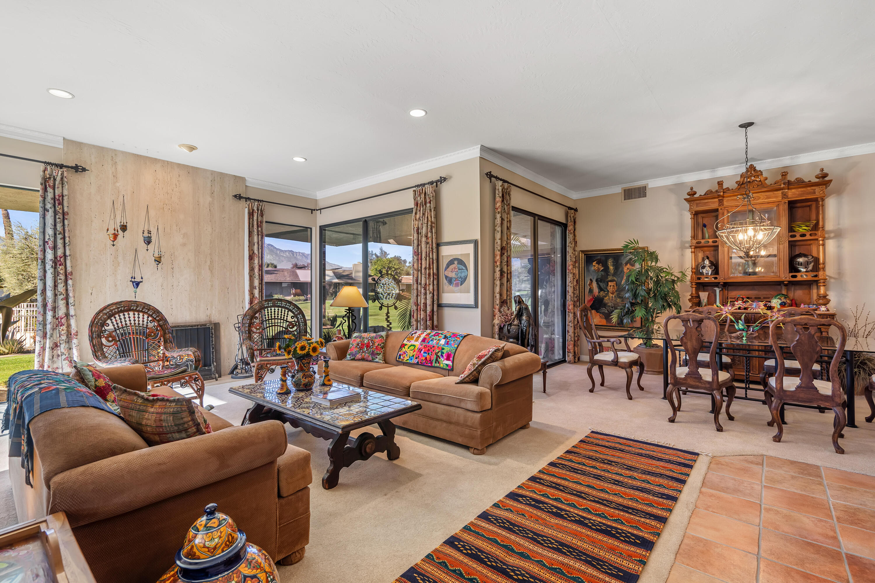 9 Swarthmore Court Rancho Mirage, CA 92270 - Photo 8 of 43 a living room with furniture a rug and a chandelier