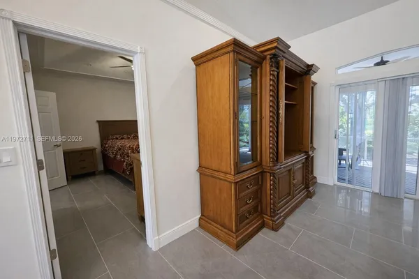 a bedroom with a bed and a view of living room