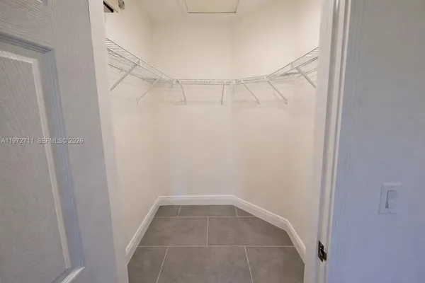 a kitchen with a sink and chairs