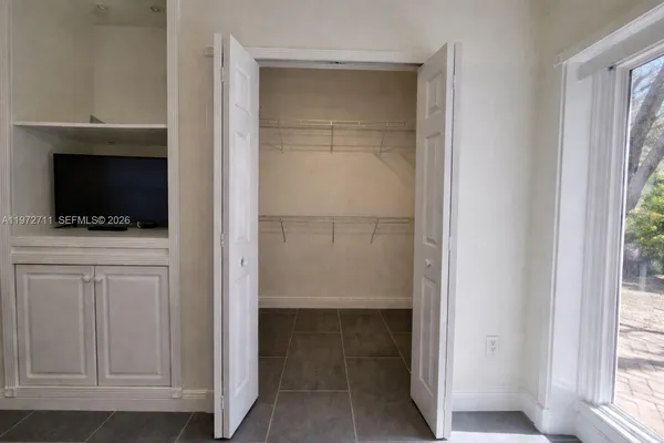 a view of a living room and floor to ceiling window