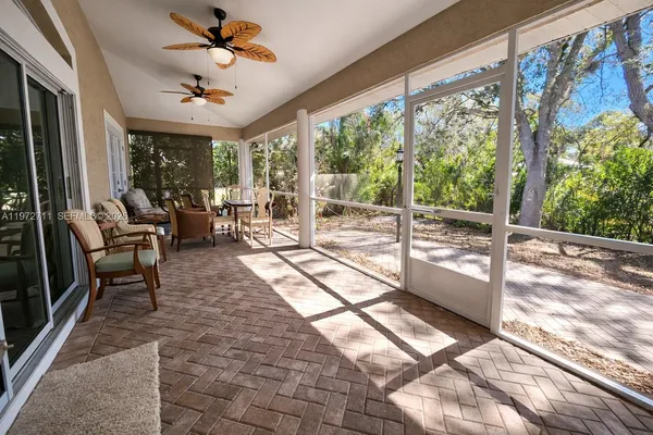 a view of a livingroom with furniture and a ceiling fan