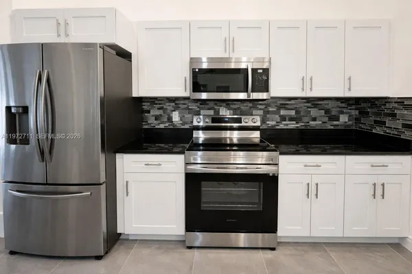 a kitchen with stainless steel appliances wooden cabinets and a stove