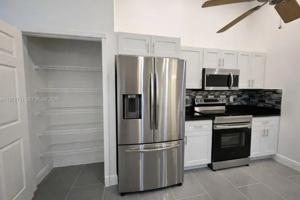 a kitchen with a refrigerator stove and microwave