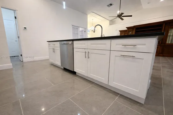 a view of a storage & utility room with cabinets