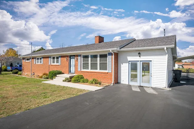 a front view of a house with a garden and porch