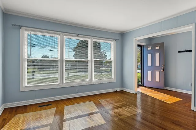 a living room with a fireplace and wooden floor