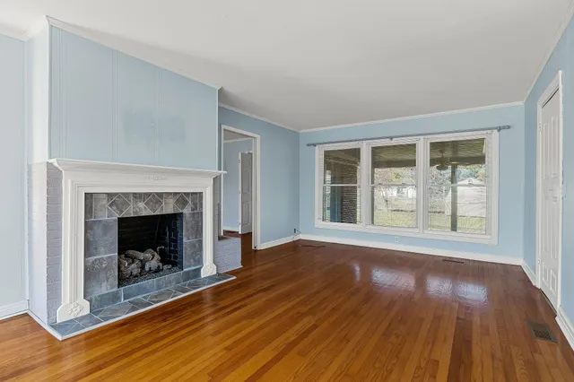 a kitchen with stainless steel appliances a stove top oven a sink and a fireplace