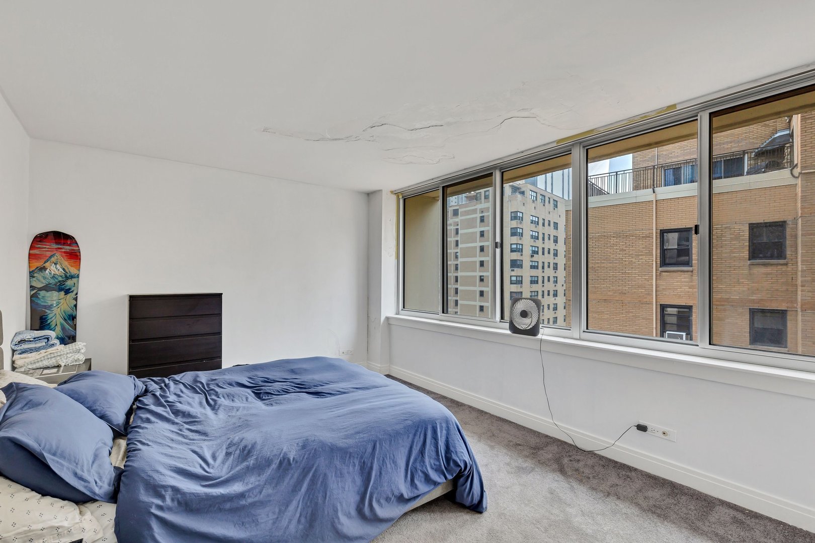 1 East Schiller Street, Unit 12A Chicago, IL 60610 - Photo 7 of 13 a bedroom with a bed and a large window