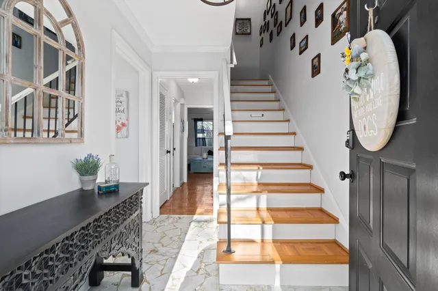 a view of entryway and hall with wooden floor