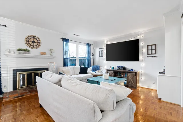 a living room with fireplace furniture and a flat screen tv
