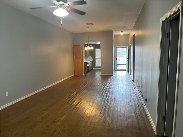wooden floor in an empty room with a mirror