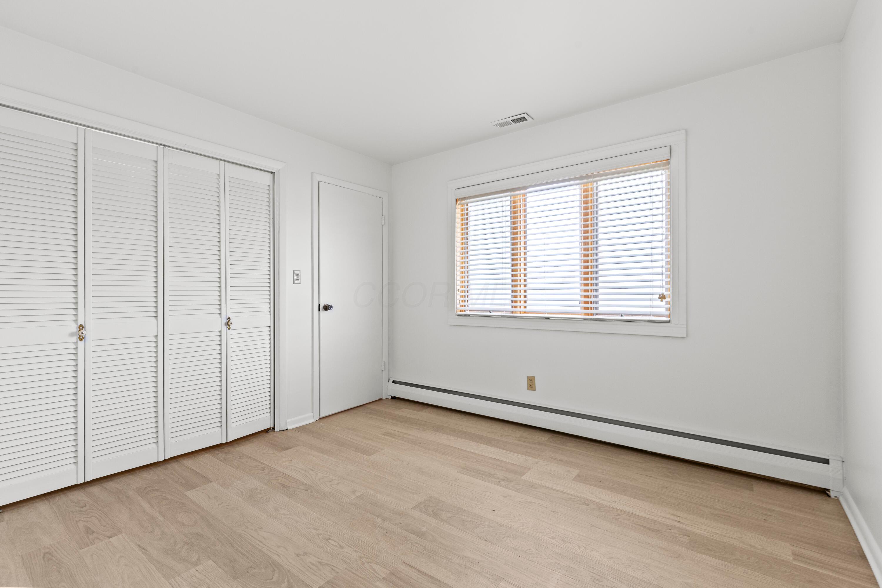 6982 Lee Road Westerville, OH 43081 - Photo 35 of 71 • New laminate flooring ~ 2024 • White painted walls • Closet with bi-fold doors • Lighted closet over stairs