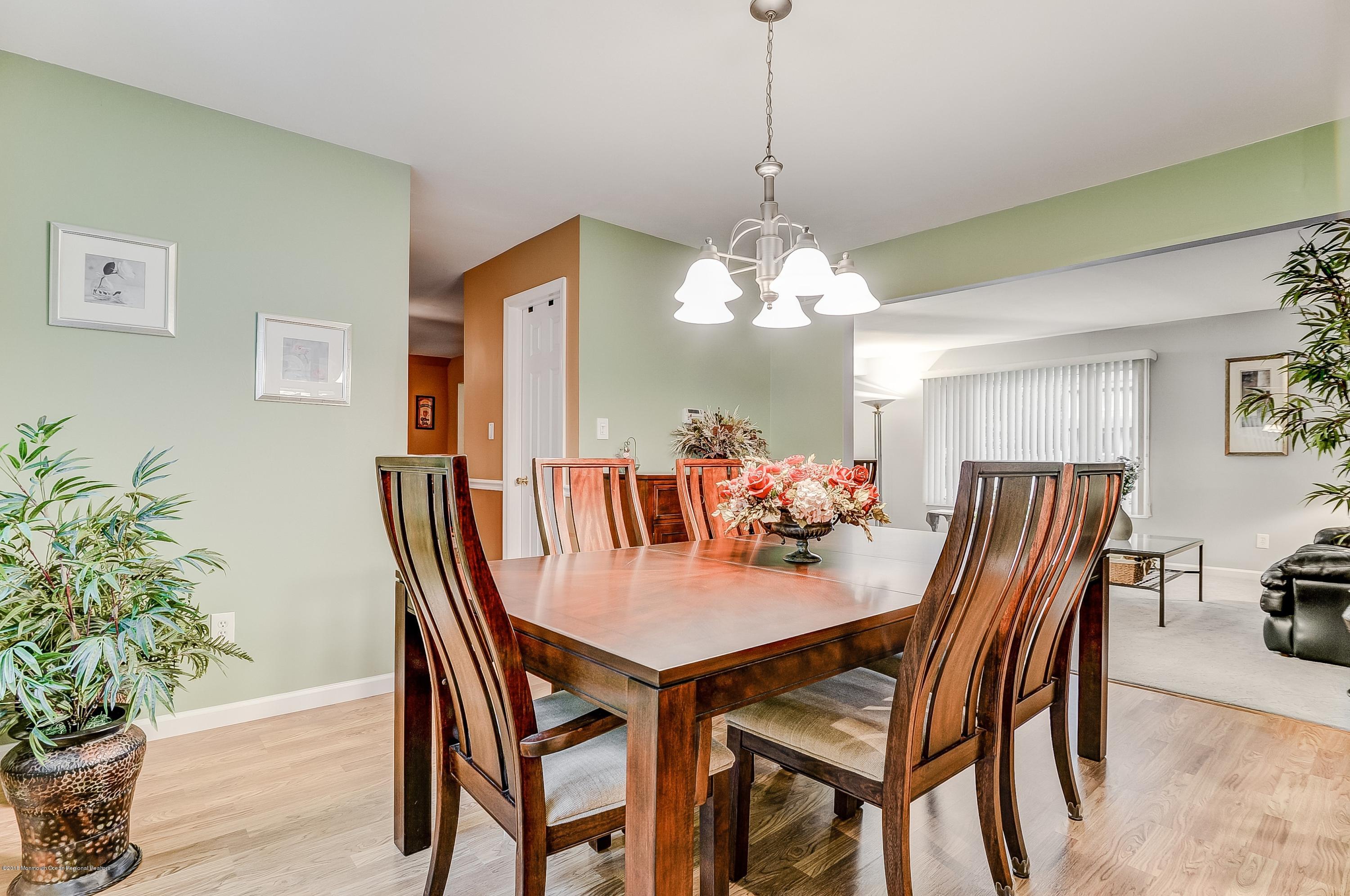 12 Addison Road Howell, NJ 07731 - Photo 12 of 25 a dining room with furniture potted plants and wooden floor
