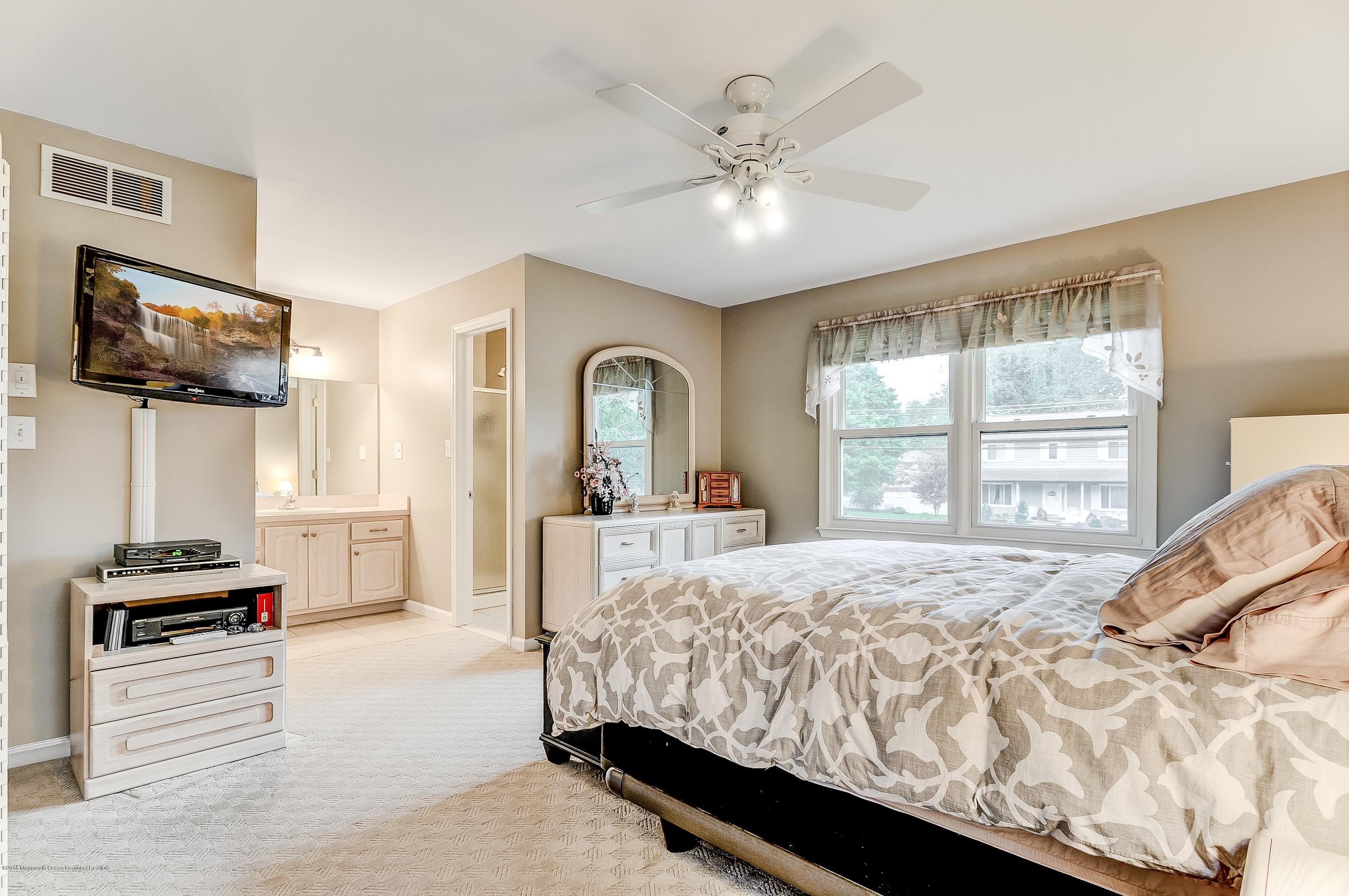 12 Addison Road Howell, NJ 07731 - Photo 17 of 25 a bedroom with a bed and a flat screen tv