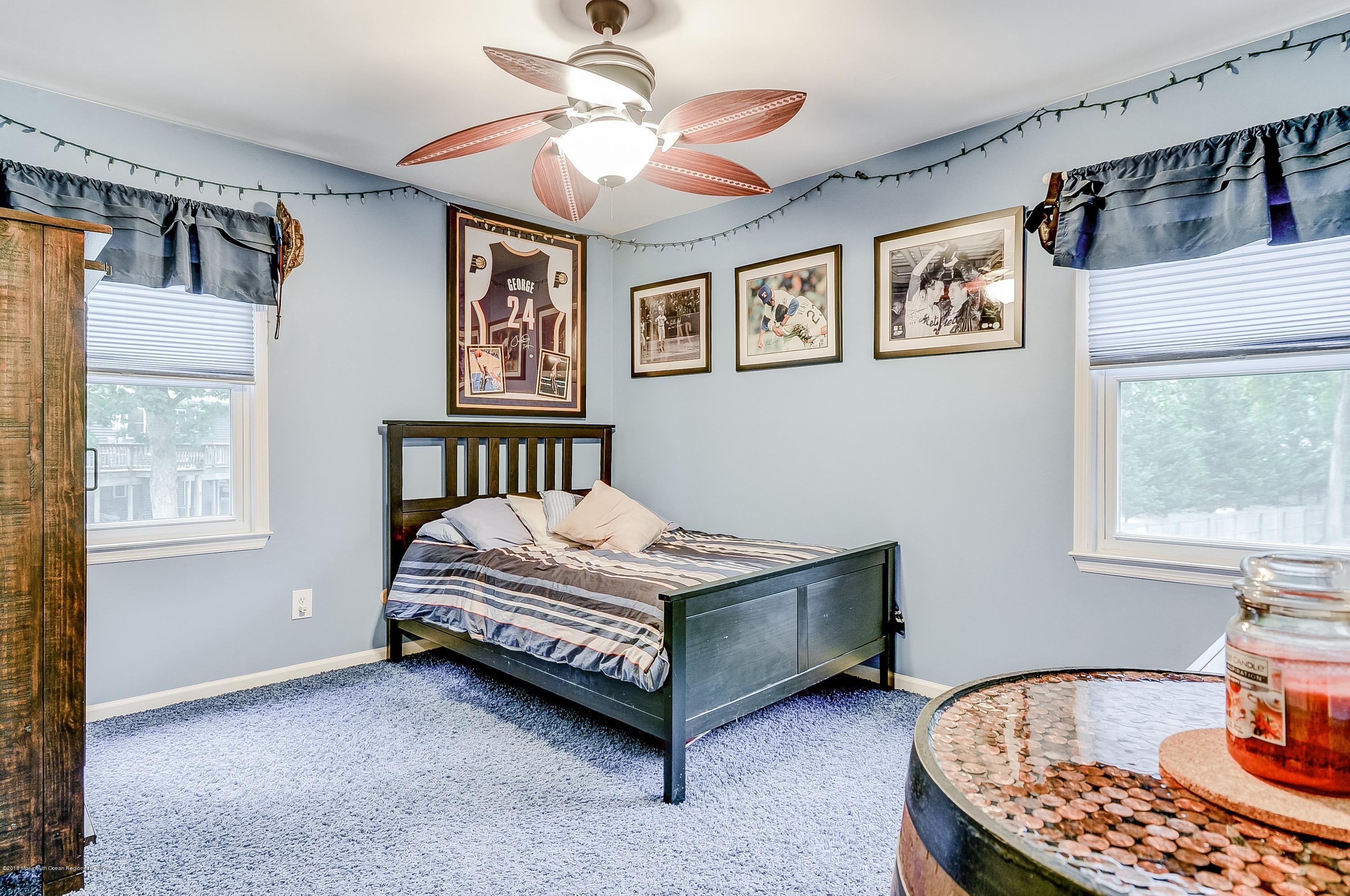 12 Addison Road Howell, NJ 07731 - Photo 19 of 25 a bed sitting in a bedroom next to a window