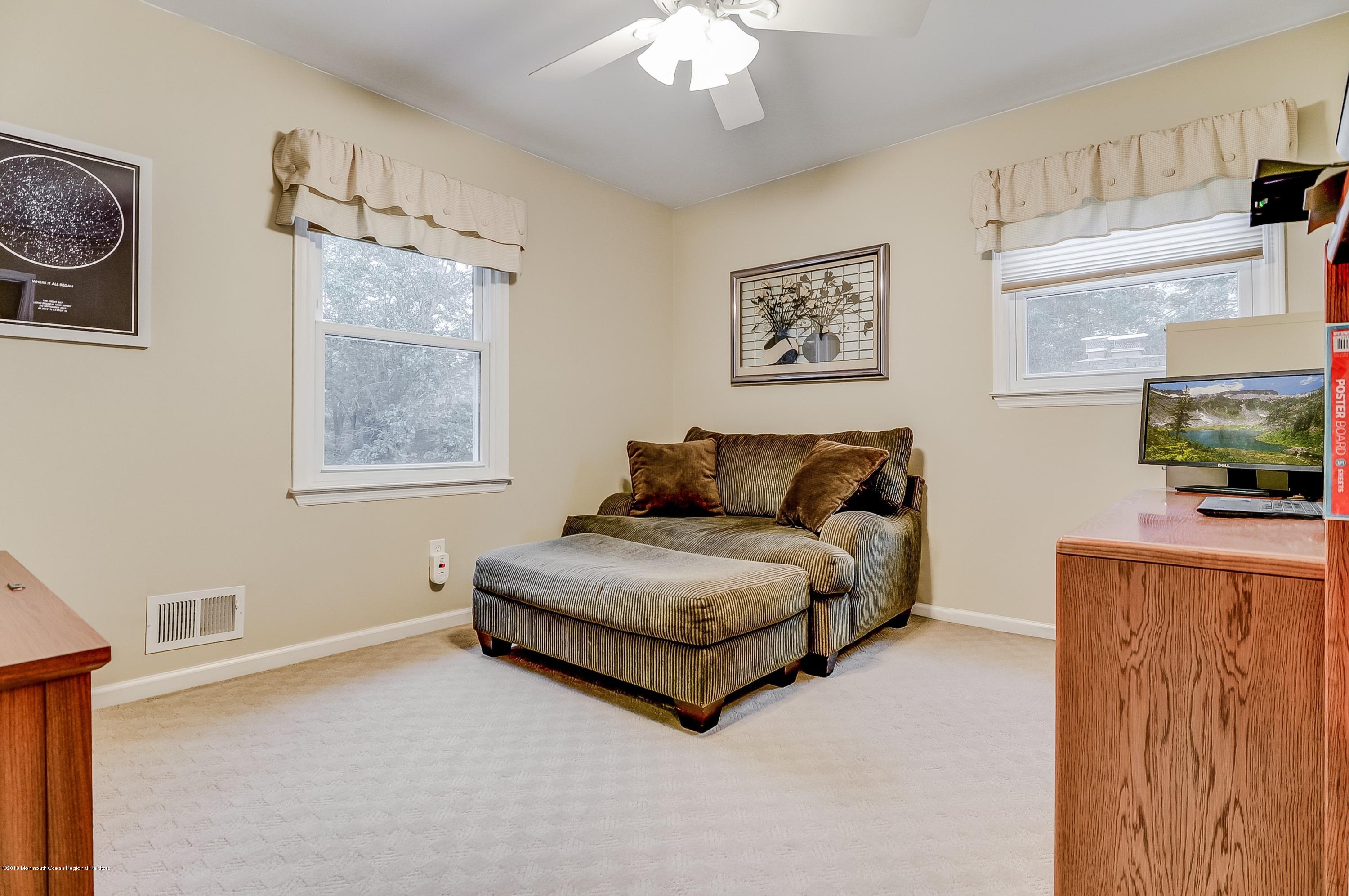 12 Addison Road Howell, NJ 07731 - Photo 21 of 25 a living room with furniture and a flat screen tv