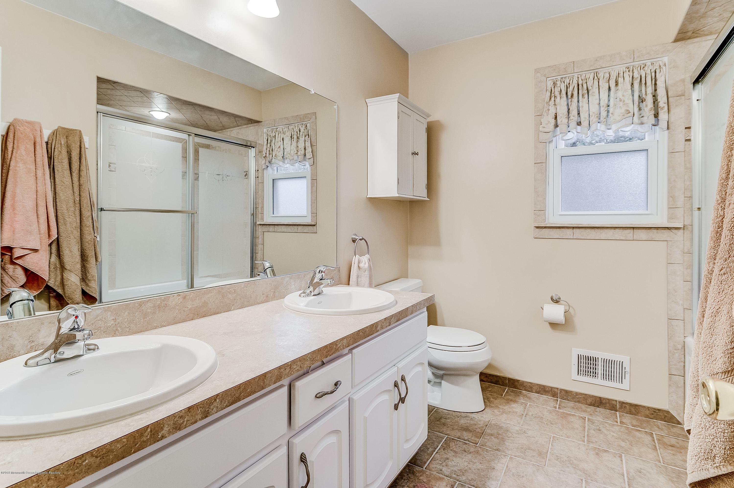 12 Addison Road Howell, NJ 07731 - Photo 22 of 25 a bathroom with a double vanity sink and a mirror