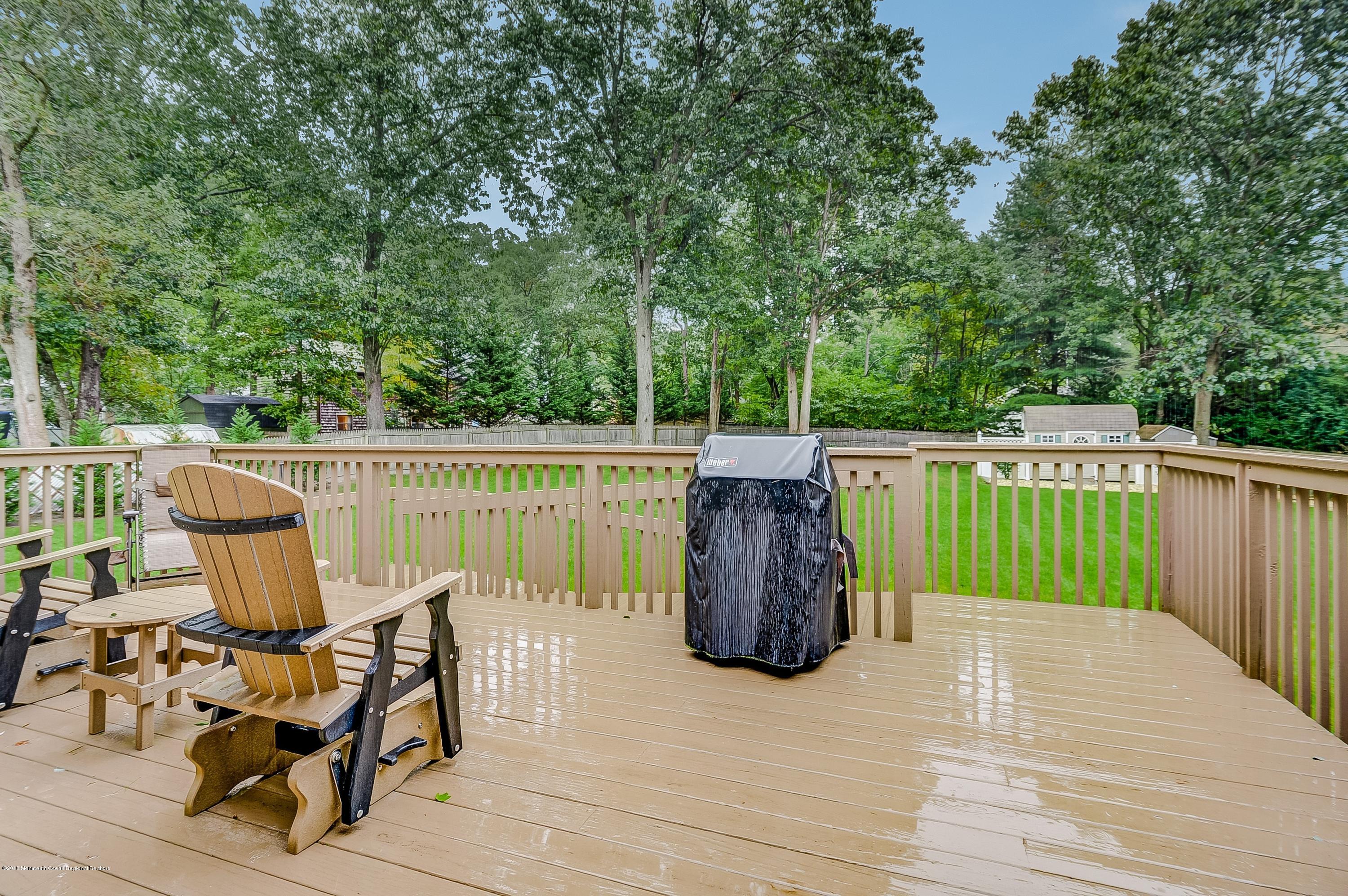 12 Addison Road Howell, NJ 07731 - Photo 25 of 25 a view of a chair and table on the wooden deck