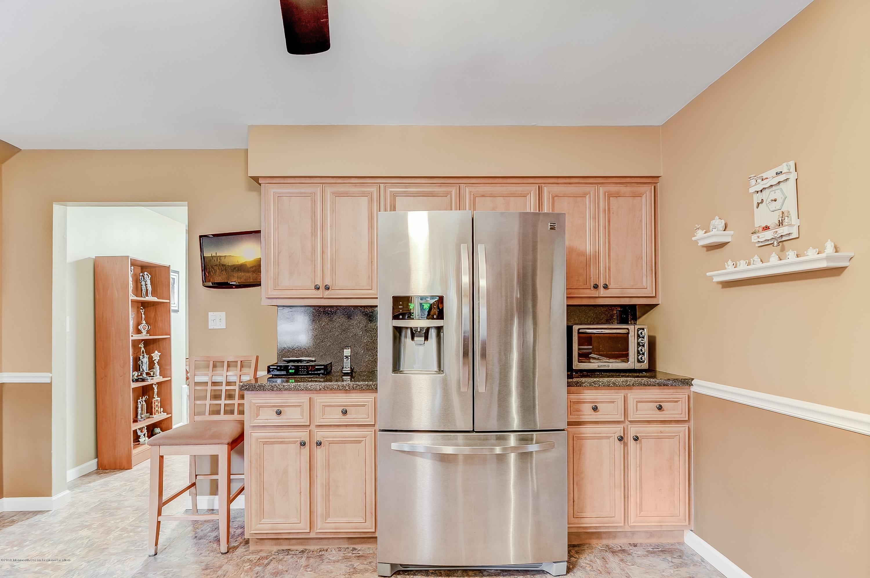 12 Addison Road Howell, NJ 07731 - Photo 6 of 25 a kitchen with stainless steel appliances a refrigerator and a stove top oven