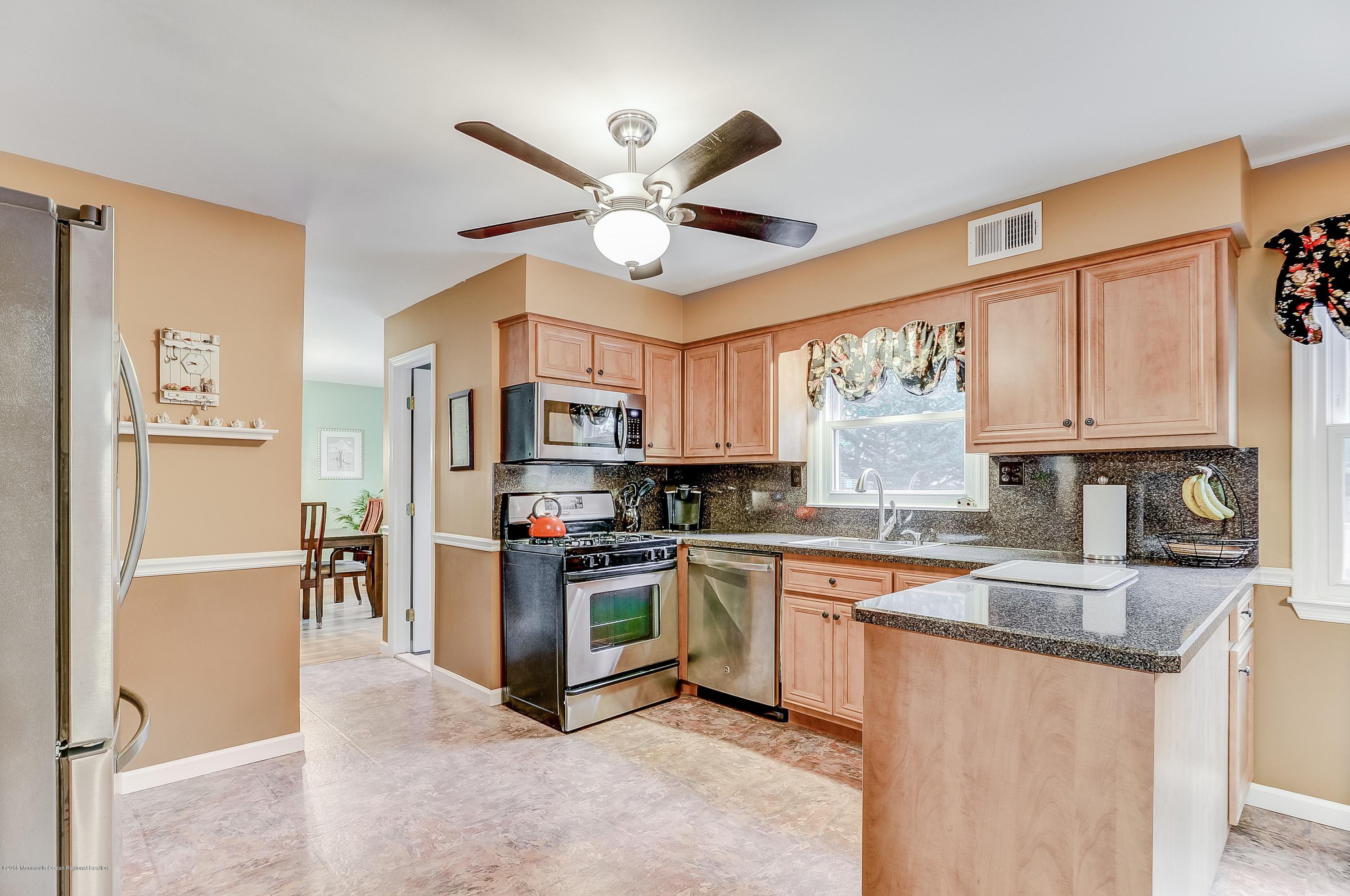 12 Addison Road Howell, NJ 07731 - Photo 7 of 25 a kitchen with stainless steel appliances granite countertop a stove top oven a refrigerator a sink and dishwasher