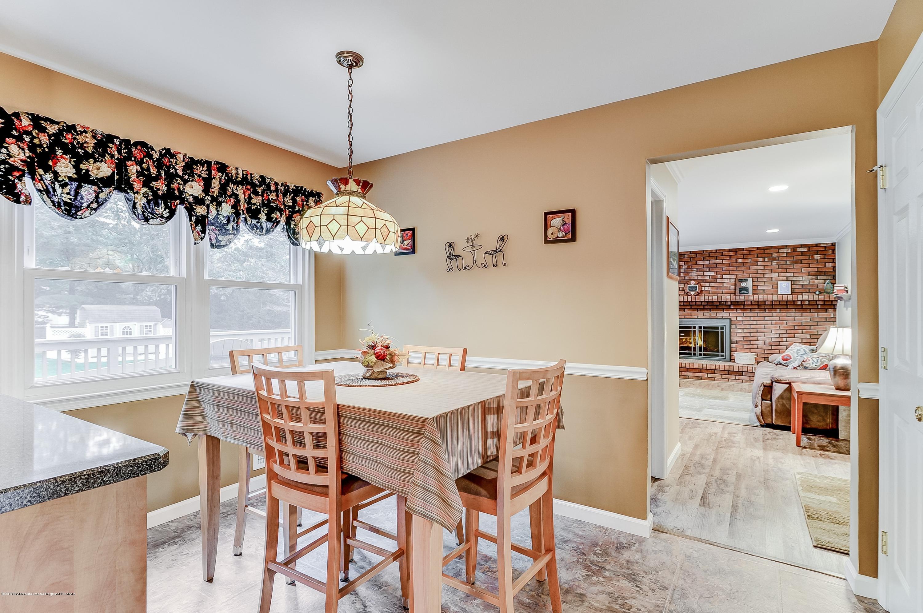 12 Addison Road Howell, NJ 07731 - Photo 8 of 25 a view of a dining room with furniture window and wooden floor