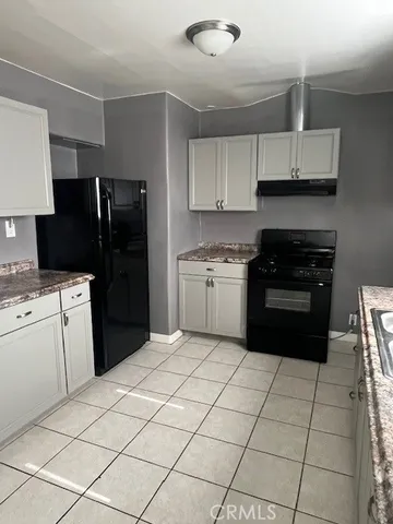 a kitchen with a sink a stove and refrigerator