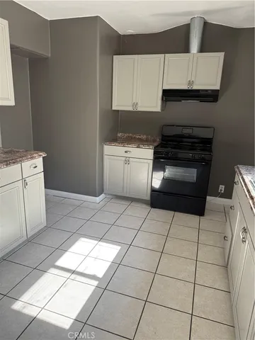 a kitchen with a stove a sink and a refrigerator