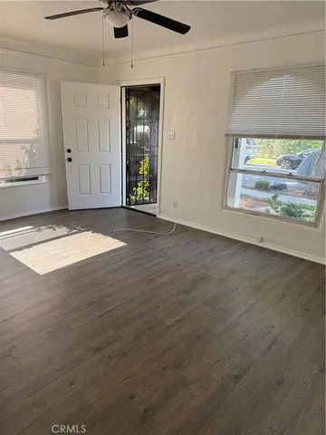an empty room with windows and closet