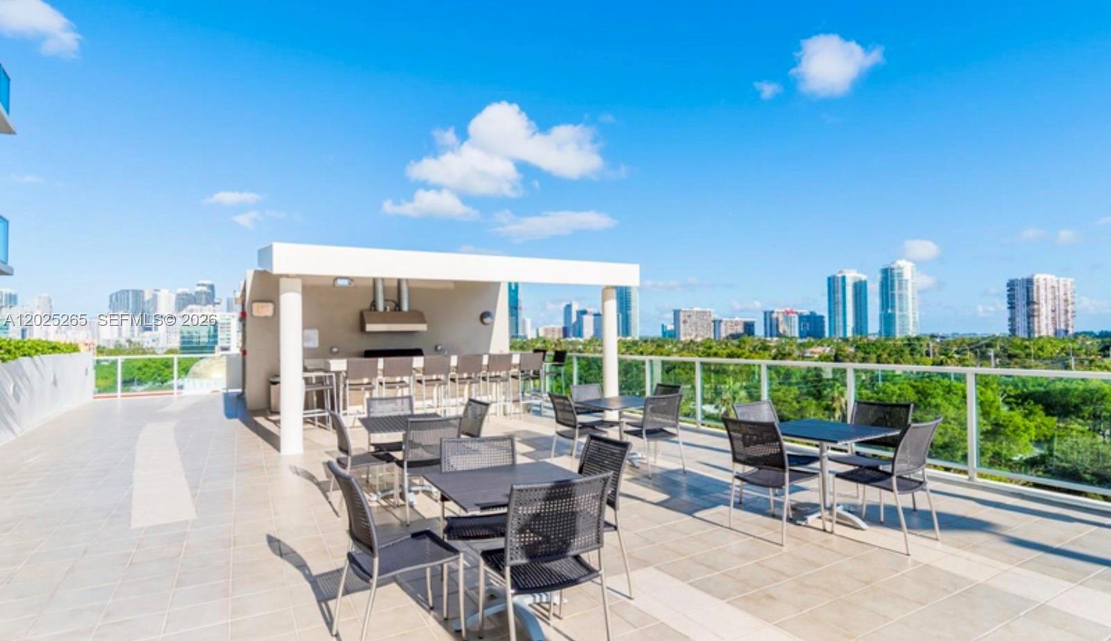 2525 Southwest 3rd Avenue, Unit 705 Miami, FL 33129 - Photo 21 of 26 a view of an chairs and table in patio with a barbeque grill