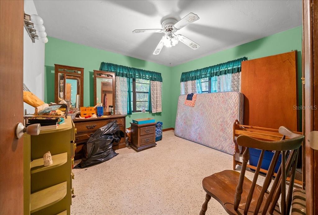 7173 West R Thomas Road Keystone Heights, FL 32656 - Photo 52 of 59 a living room with furniture a ceiling fan and a window