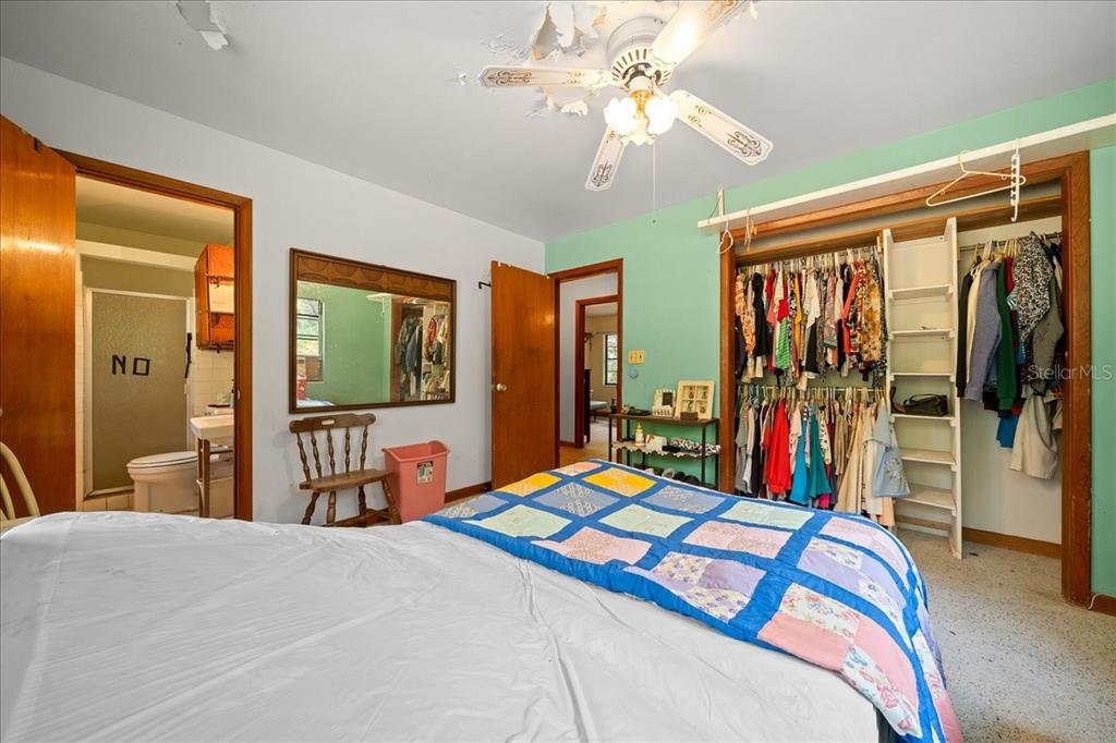 7173 West R Thomas Road Keystone Heights, FL 32656 - Photo 55 of 59 a bedroom that has a bed and a chandelier