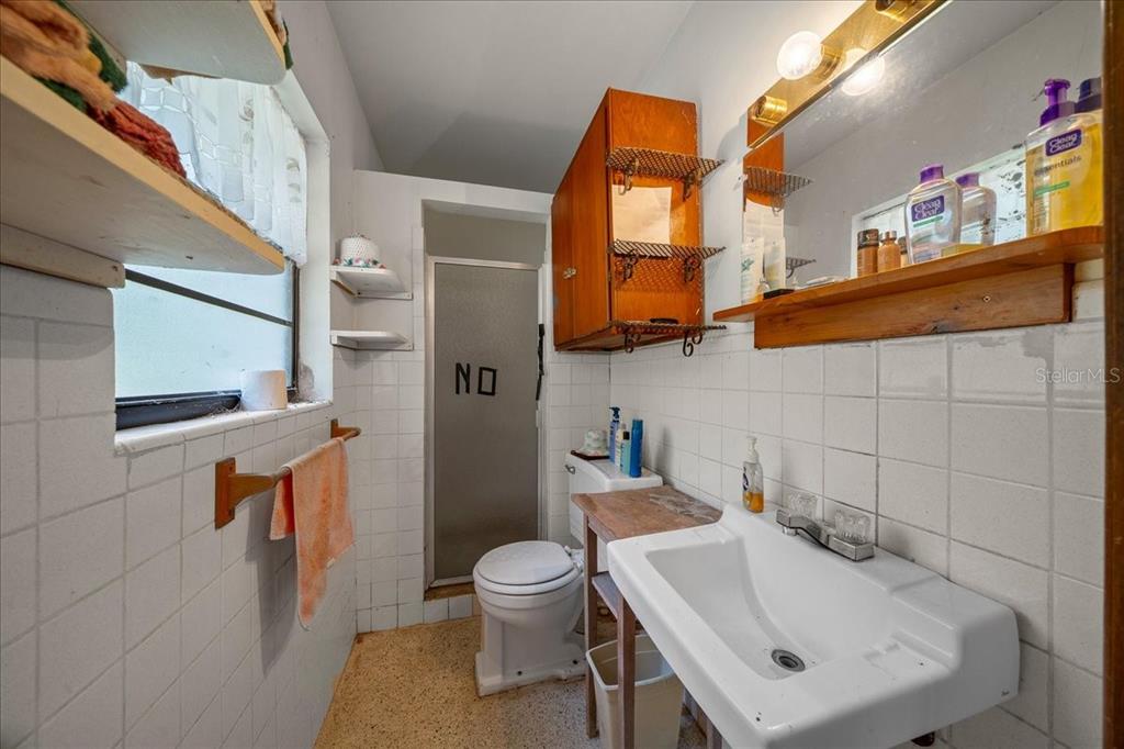 7173 West R Thomas Road Keystone Heights, FL 32656 - Photo 59 of 59 a bathroom with a sink a toilet and mirror