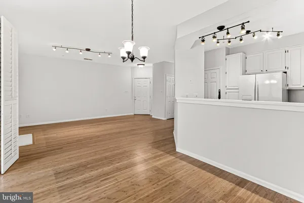 a kitchen with stainless steel appliances a stove top oven and a refrigerator
