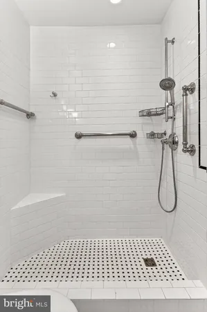 a living room with furniture a rug and a table