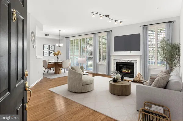 a view of empty room with wooden floor and fireplace
