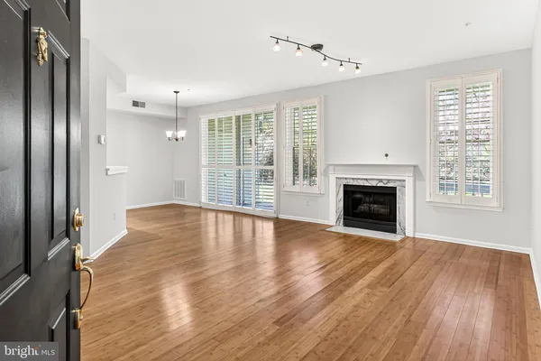 wooden floor in an empty room with a fireplace