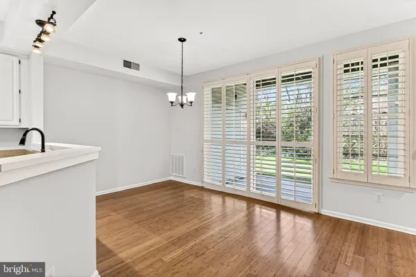 a view of empty room with wooden floor and fireplace