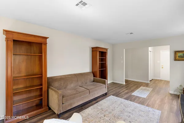 a living room with a couch and a walk in closet