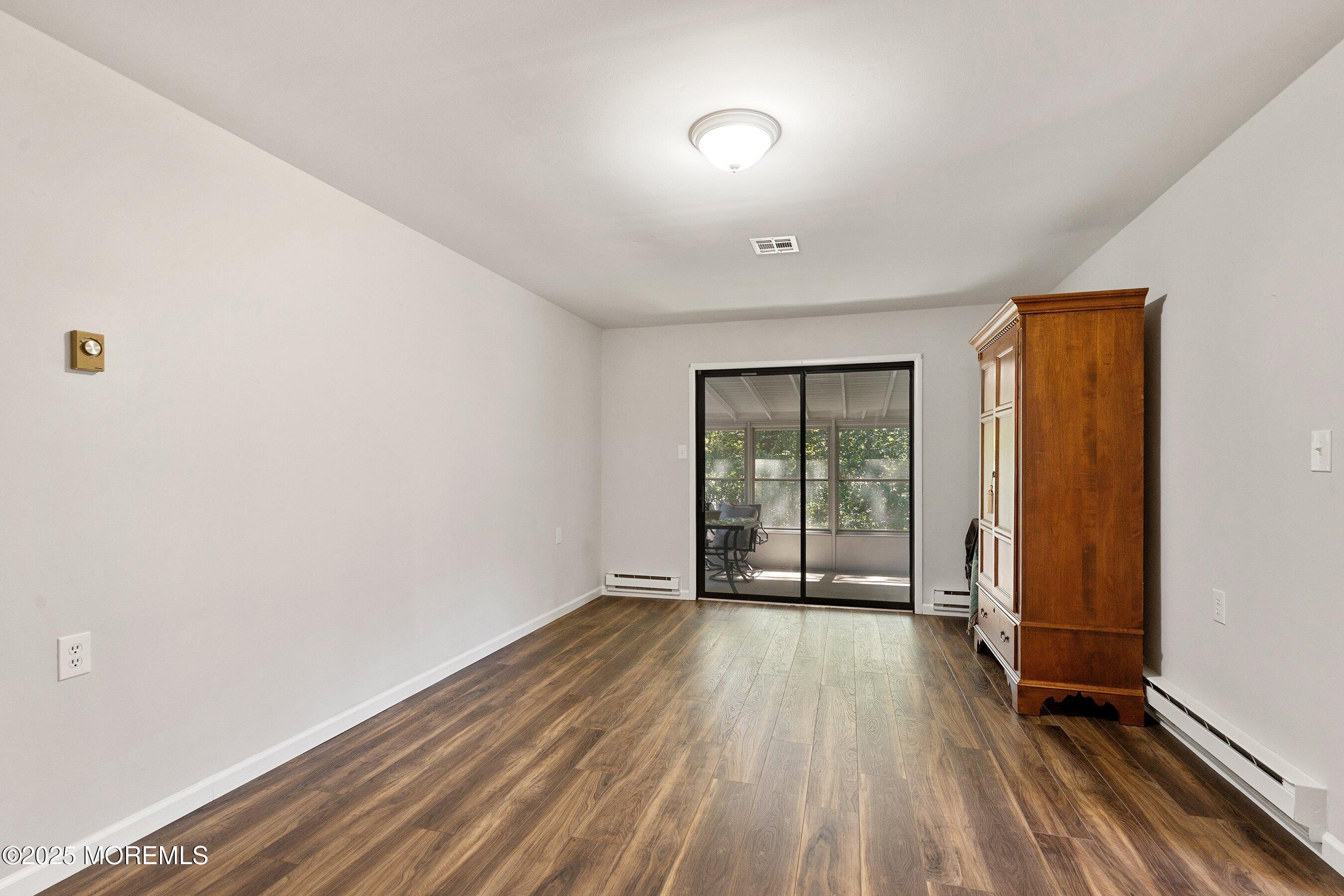 9 Whitney Court Brick, NJ 08724 - Photo 17 of 42 wooden floor in an empty room with a window