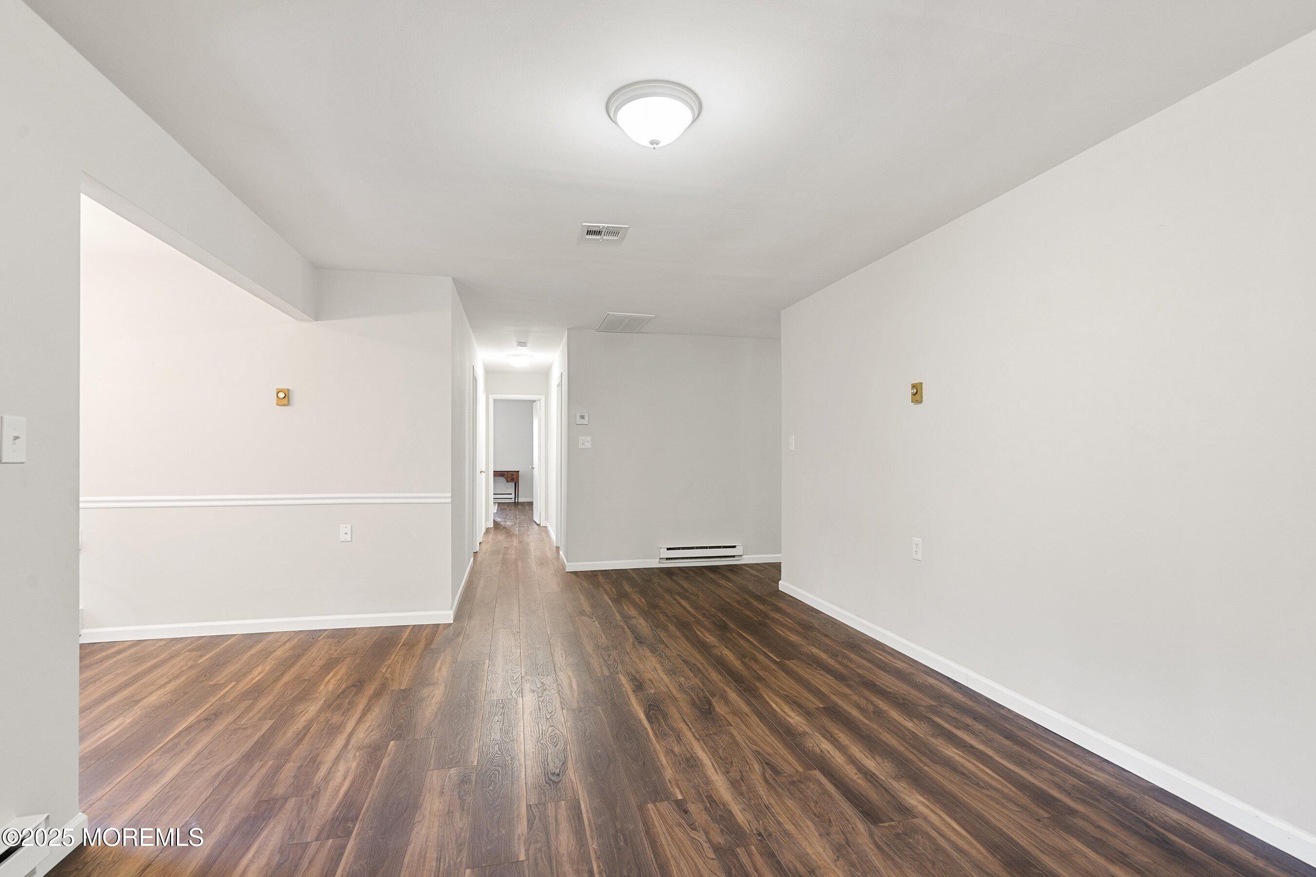 9 Whitney Court Brick, NJ 08724 - Photo 18 of 42 a view of an empty room with wooden floor