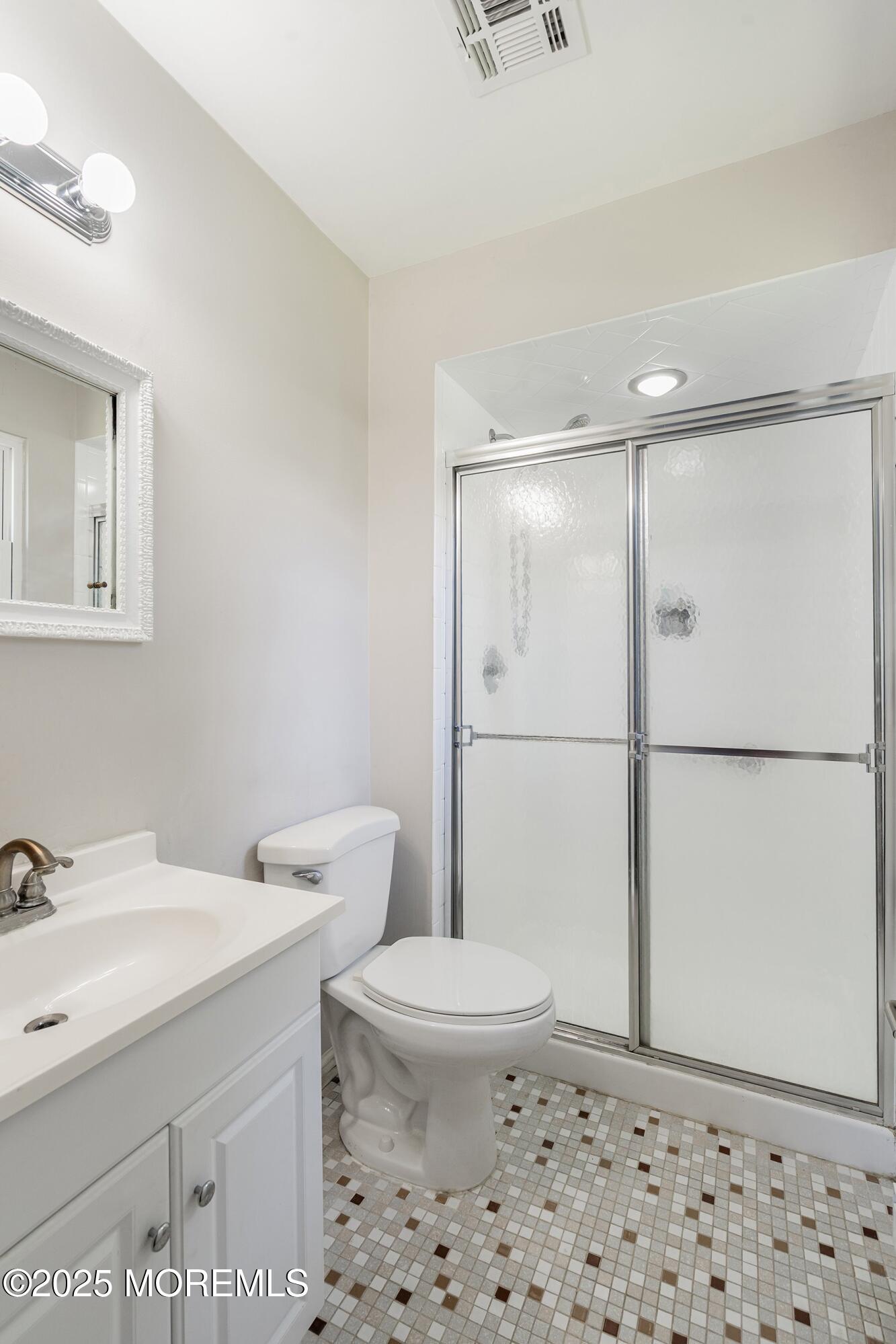 9 Whitney Court Brick, NJ 08724 - Photo 19 of 42 a bathroom with a sink a toilet a shower and a mirror