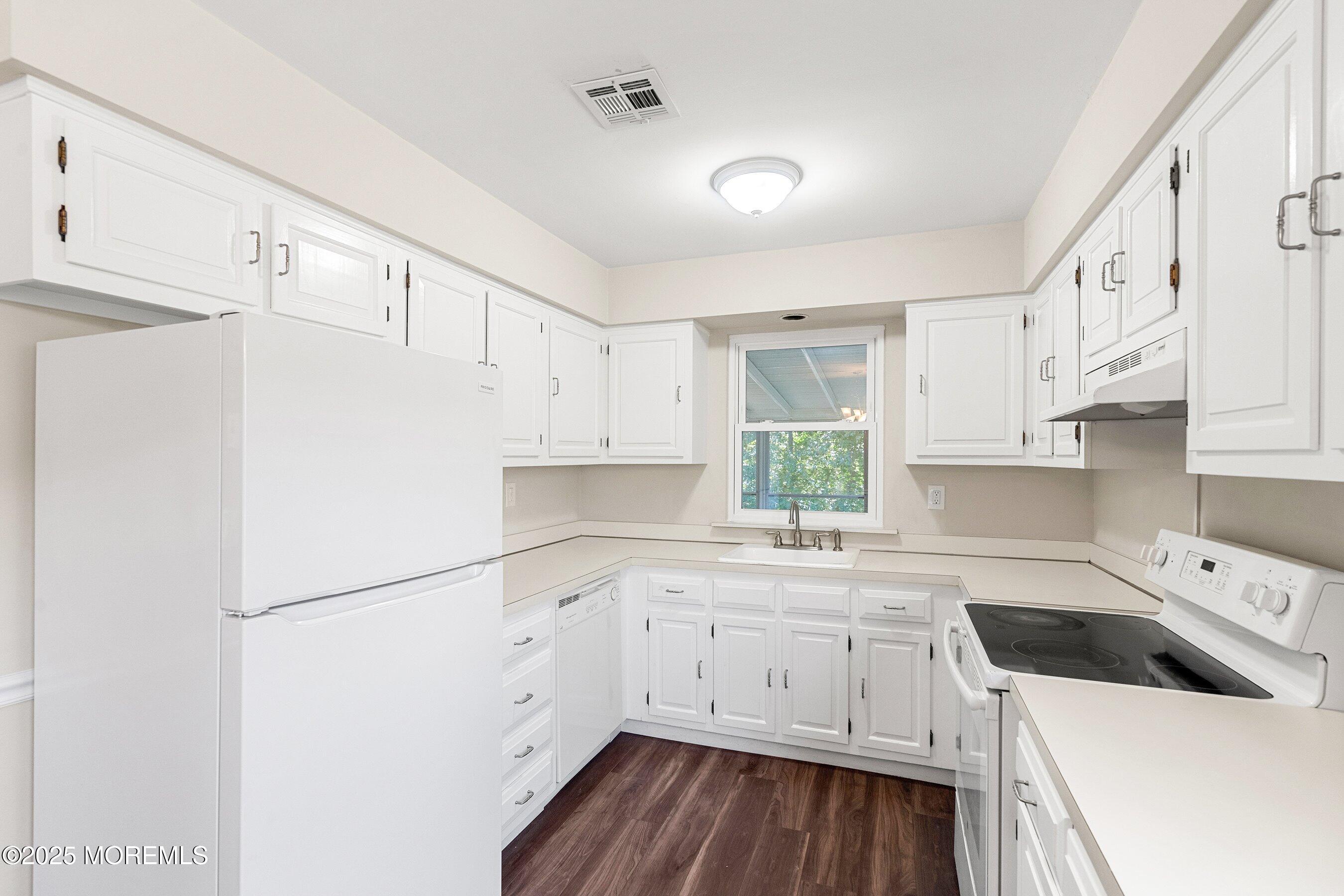 9 Whitney Court Brick, NJ 08724 - Photo 22 of 42 a kitchen with white cabinets white appliances and sink