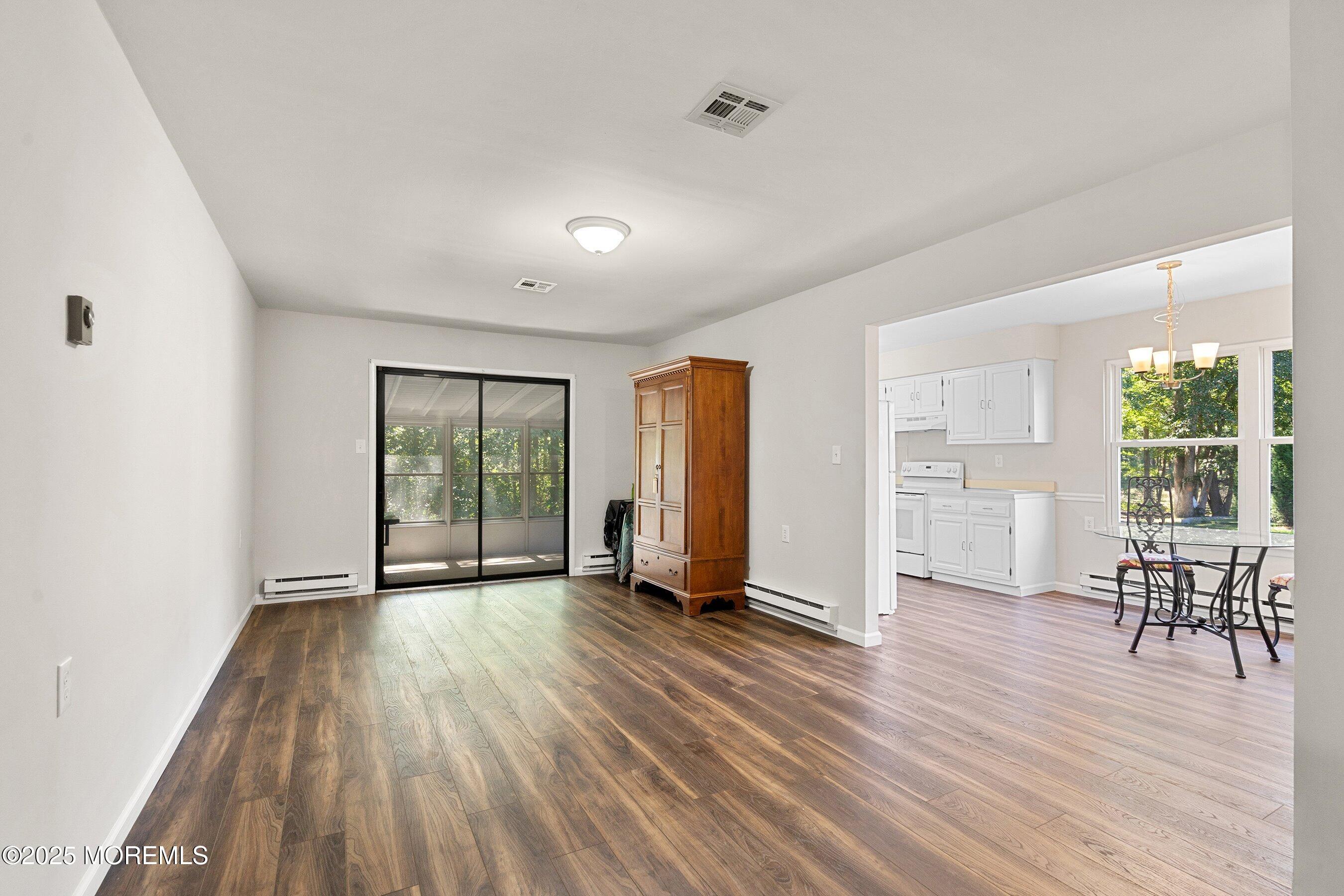 9 Whitney Court Brick, NJ 08724 - Photo 3 of 42 an empty room with wooden floor and windows