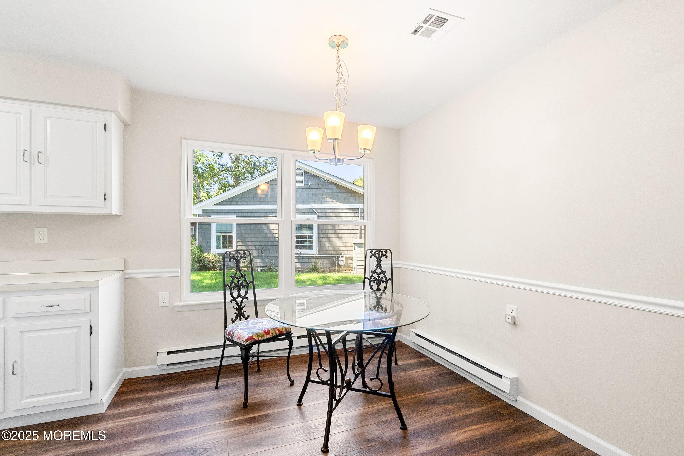 9 Whitney Court Brick, NJ 08724 - Photo 6 of 42 a view of a dining room with furniture window and wooden floor