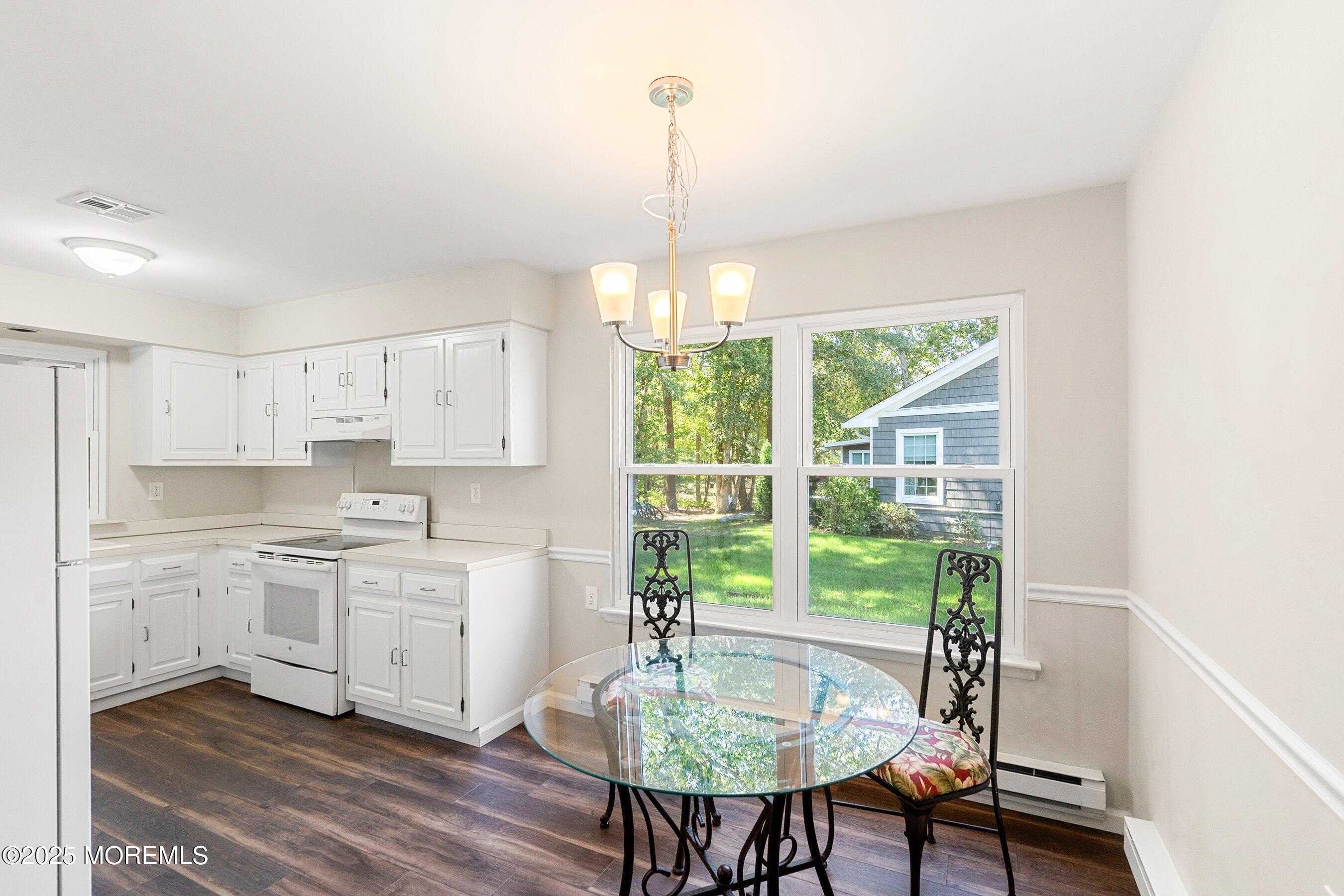 9 Whitney Court Brick, NJ 08724 - Photo 7 of 42 a kitchen with a table and chairs in it