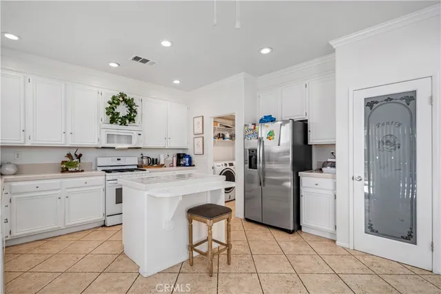 a kitchen with refrigerator and cabinets