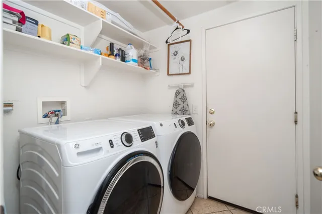 a view of washer and dryer with kitchen in the background
