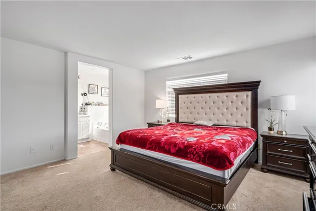 a bed sitting in a bedroom next to a window with dresser