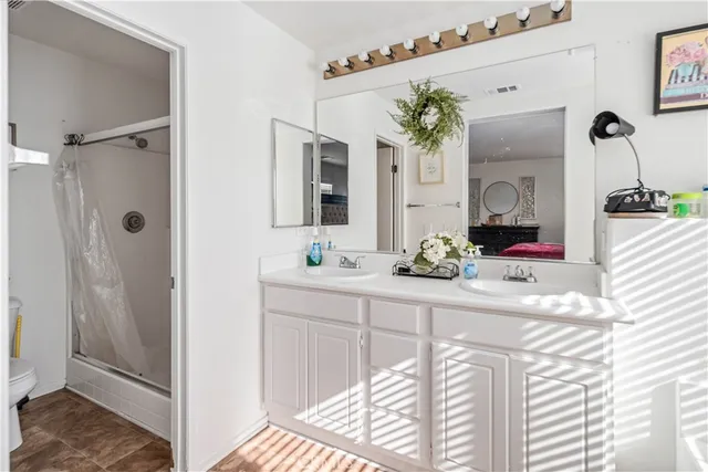 a bathroom with a sink a large mirror and a bathtub