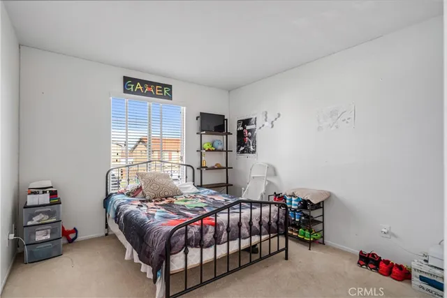 a bedroom with a bed and a dresser in it